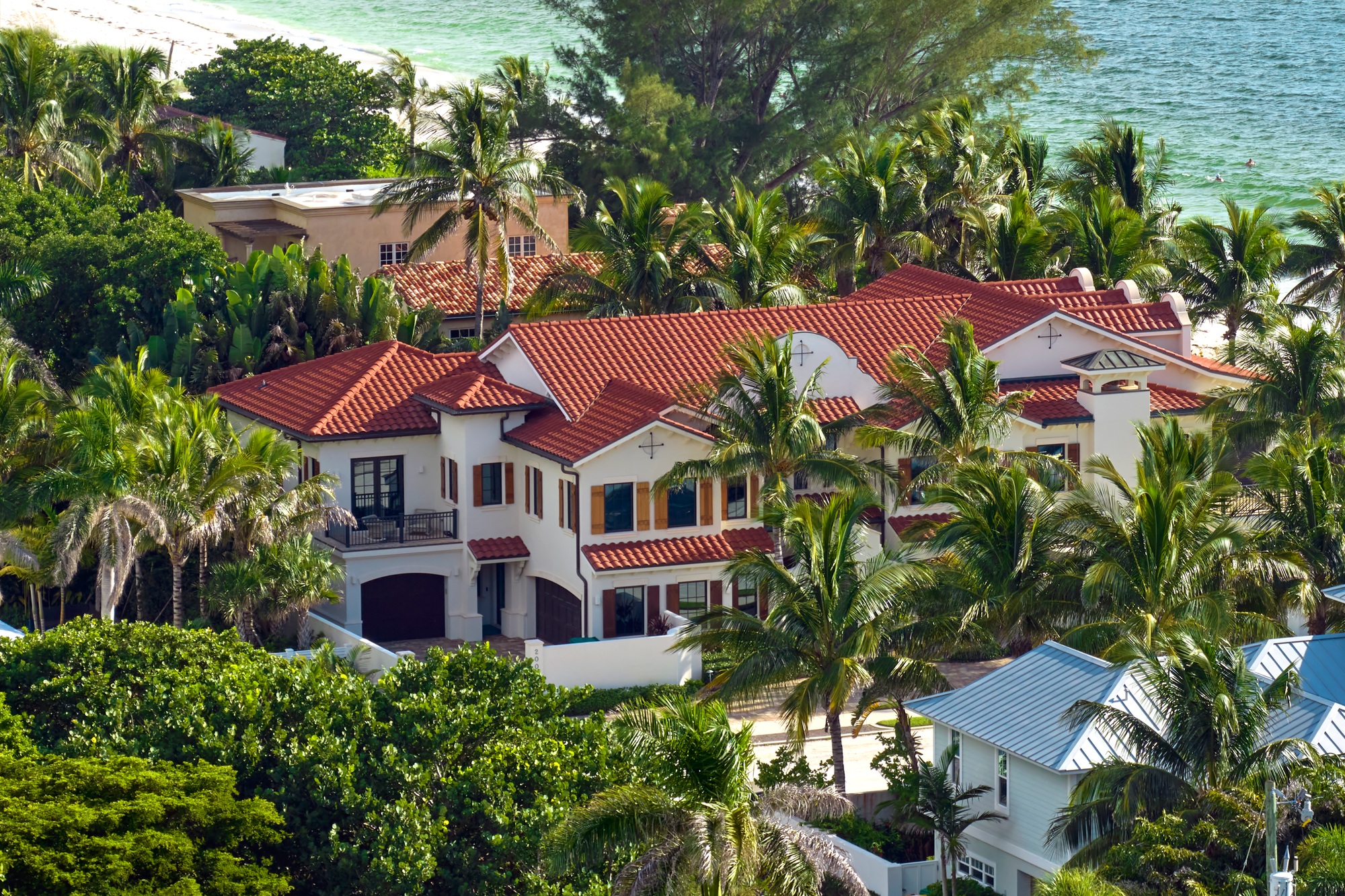 View from above of large residential houses in closed living golf club in south Florida.